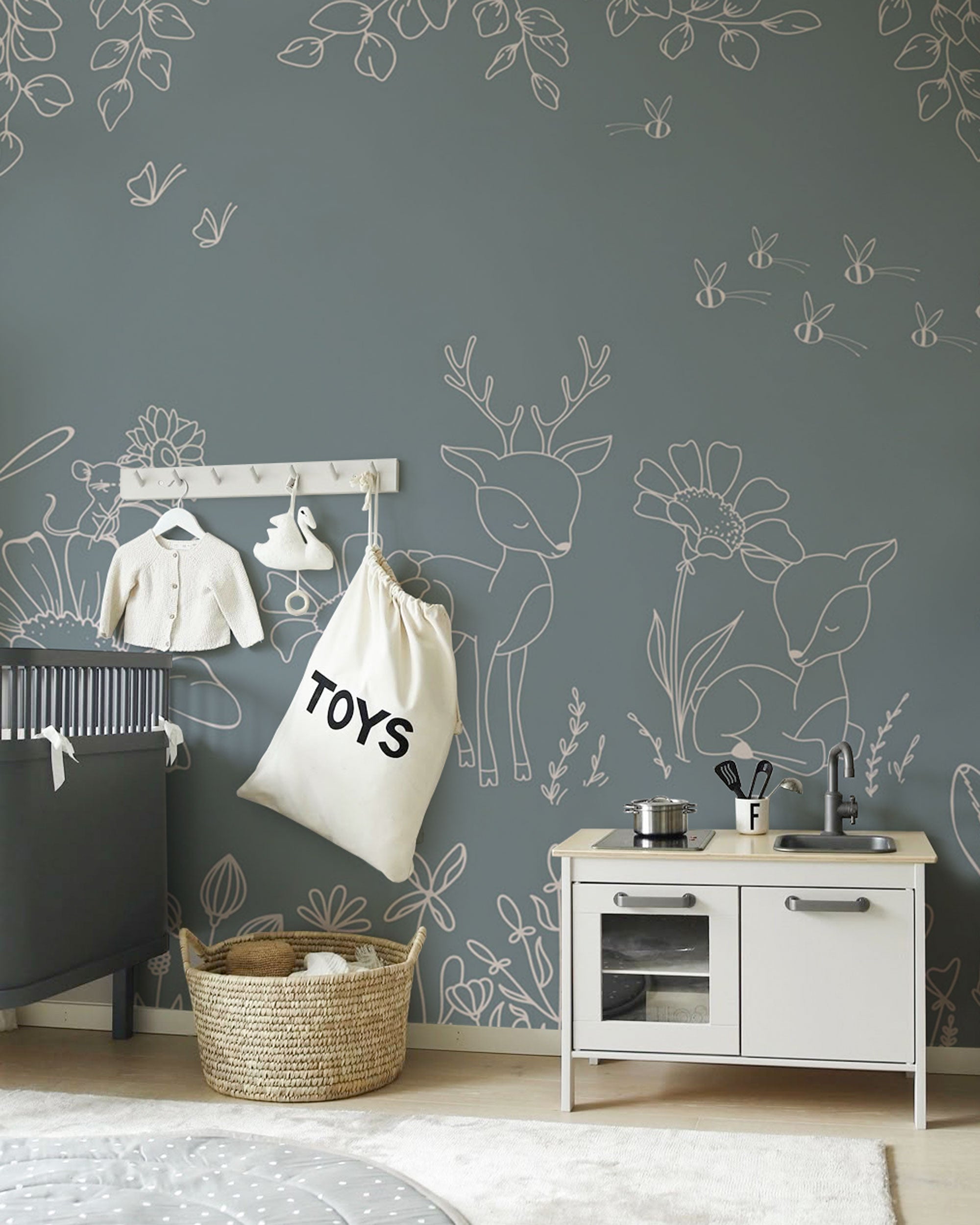 blue wallpaper with white line art deer, woodland animals and floral illustrations