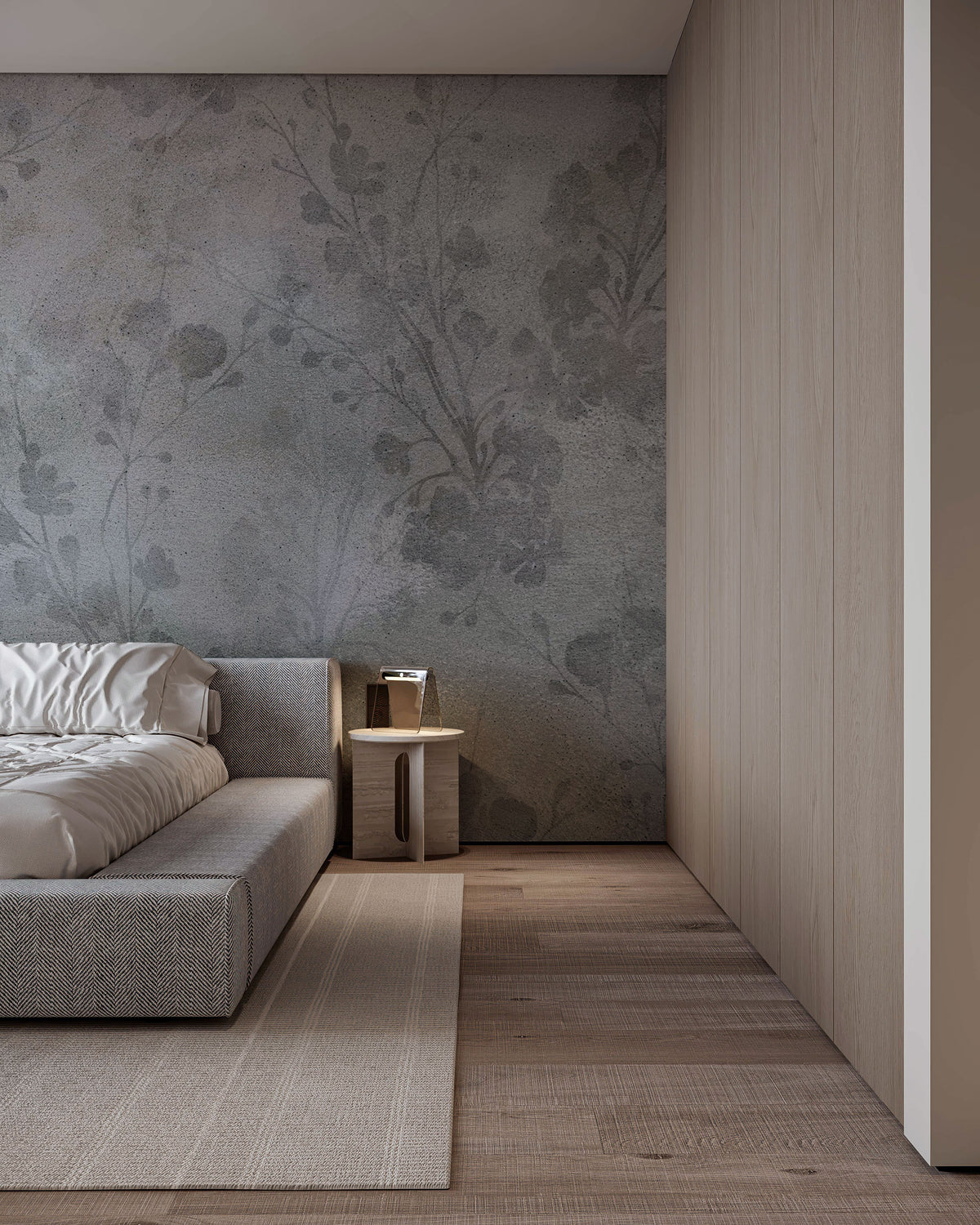 Soft grey wallpaper with subtle botanical silhouettes over a concrete-textured background in muted neutral tones