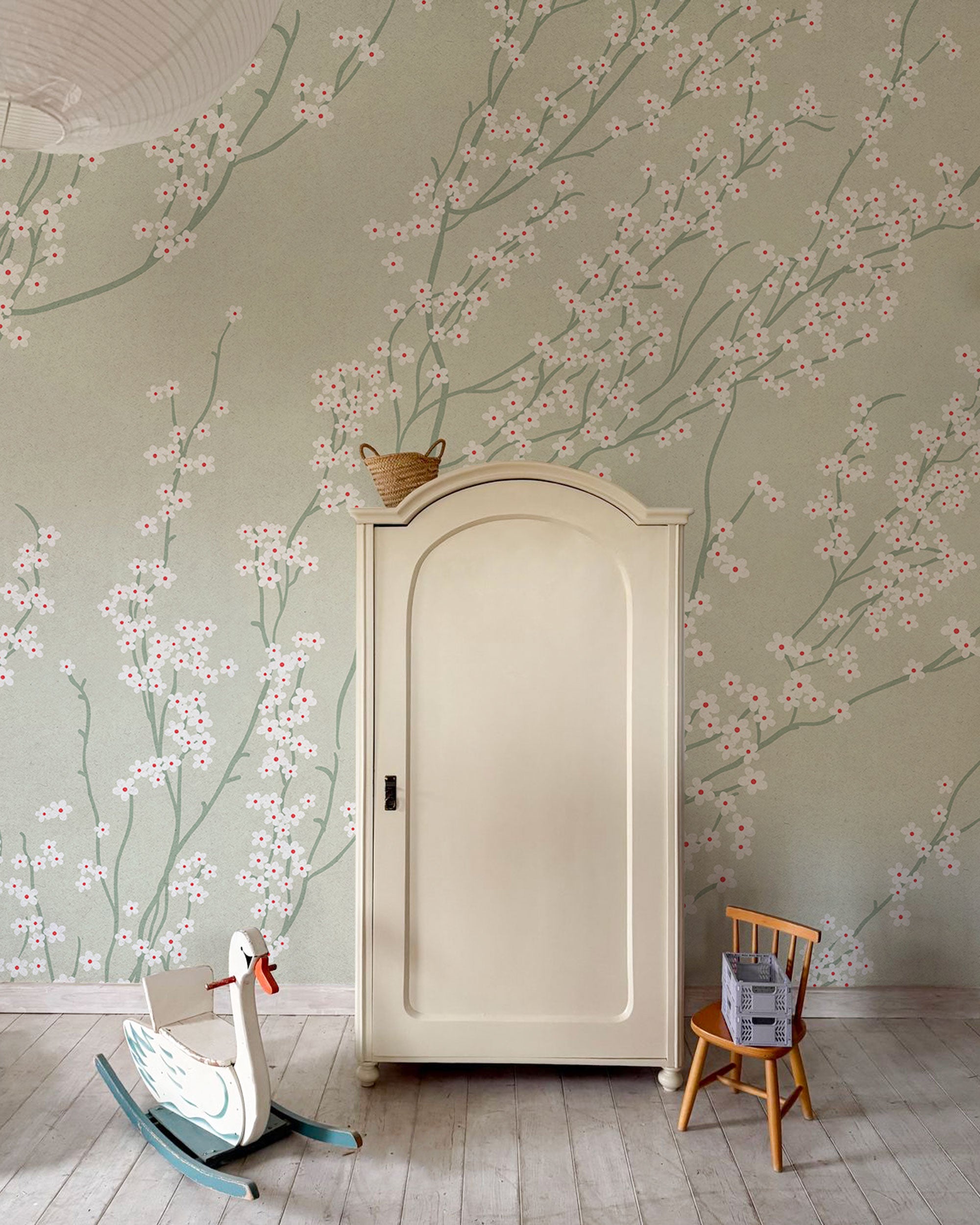 Soft pastel wallpaper with delicate cherry blossom branches, small white flowers, and slender green stems on a muted sage green background