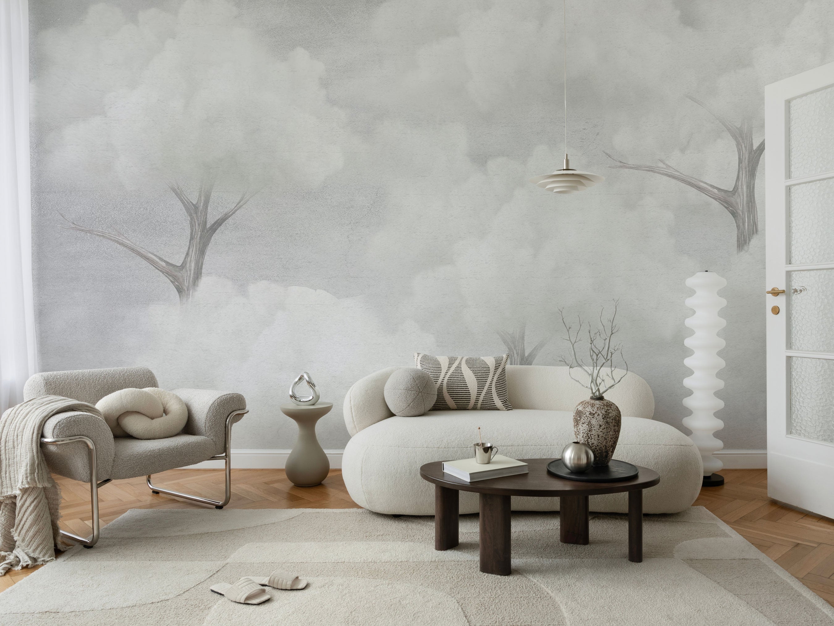 Skytree mural wallpaper with grey clouds and abstract forest tree silhouettes.