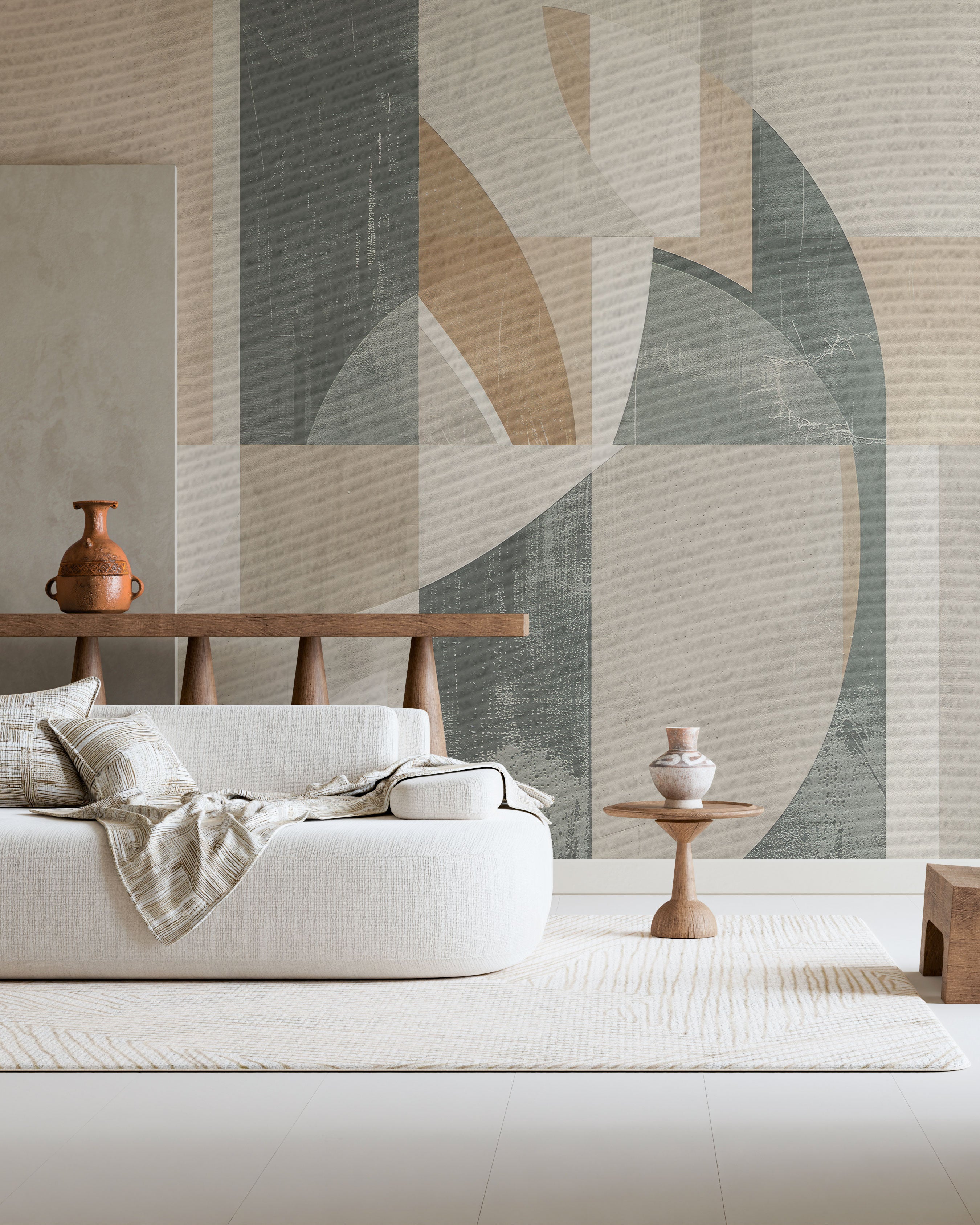 Abstract geometric mural wallpaper with green and beige shapes, curved forms, and textured earth tones.