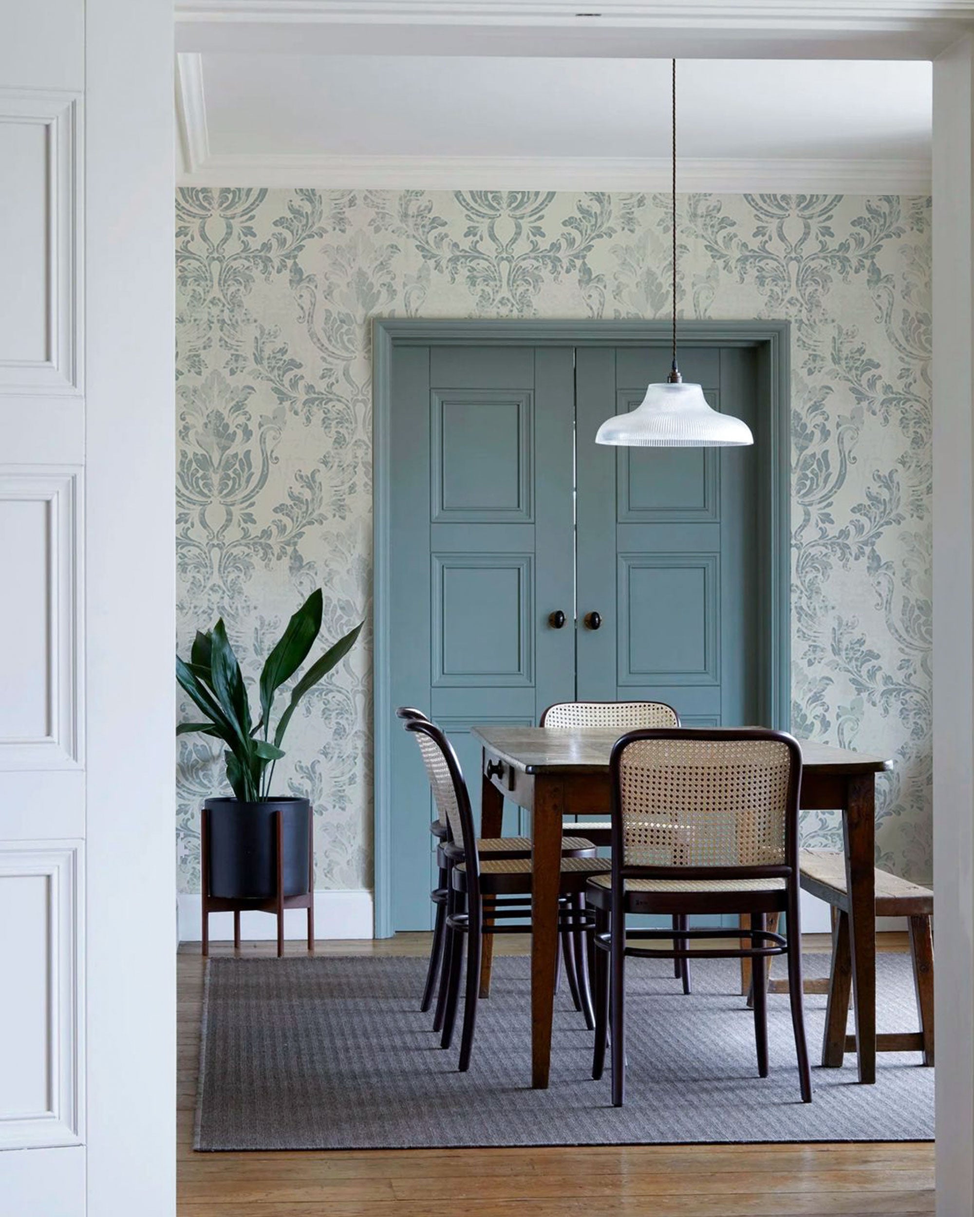 Vintage damask wallpaper in soft blue-grey and ivory tones with a subtle textured finish 